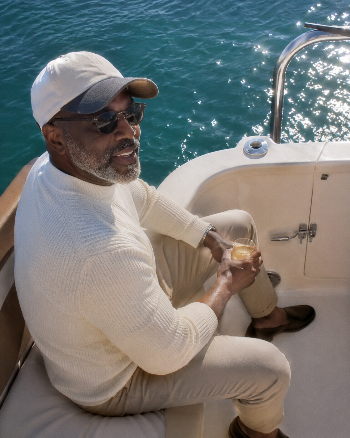 Cream knit and tailored trousers on the water